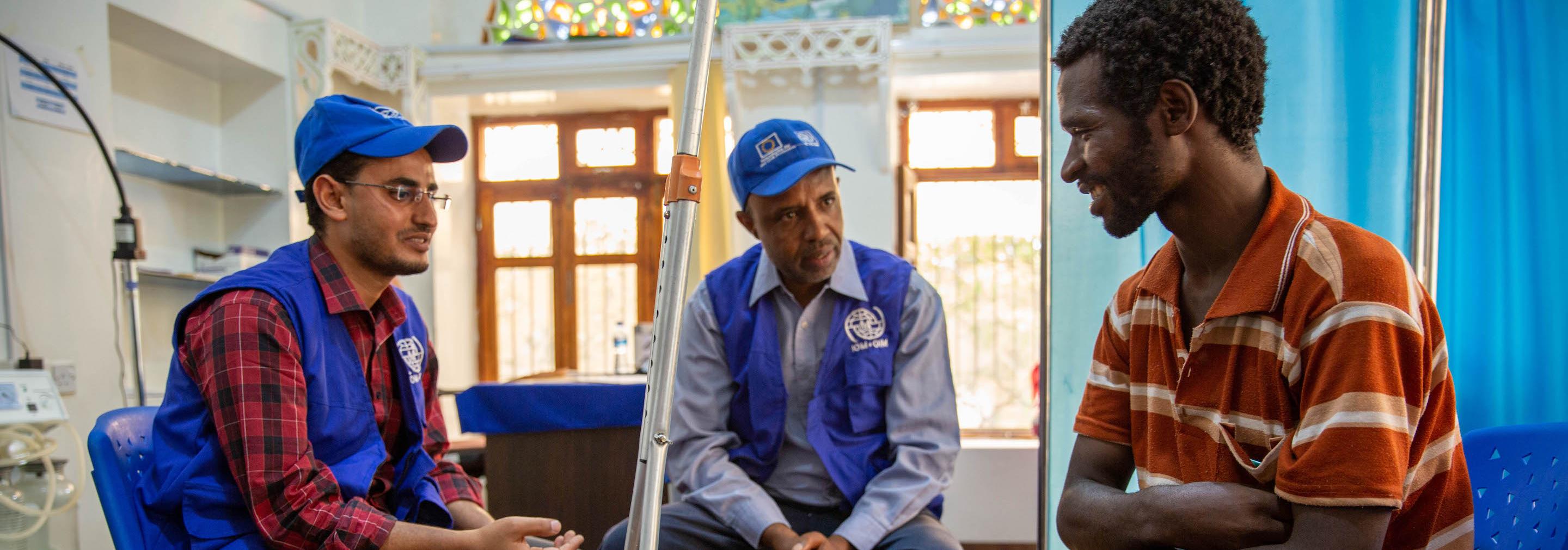 Through the help of an interpreter, an IOM doctor checks in with a migrant who was injured in Yemen and is receiving follow care from IOM. Credit Olivia Headon copyright IOM 2019